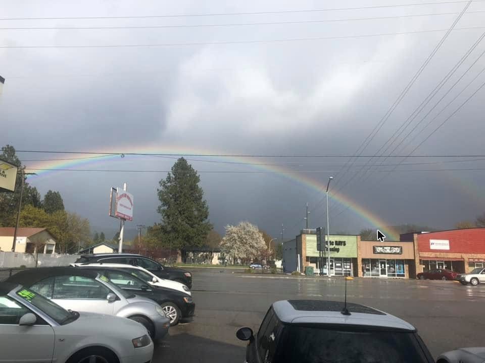Cars for sale on the European Machine lot in Coeur d'Alene under a rainbow